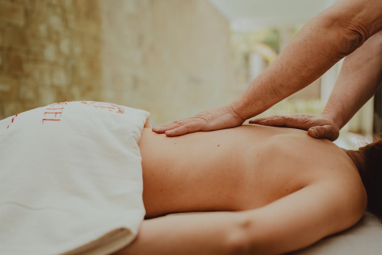 A soothing massage therapy session in a tranquil spa setting focusing on relaxation and wellness.